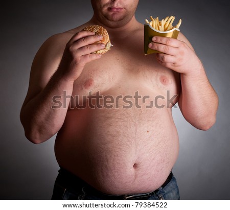 Fat man with hamburger and chips on dark background