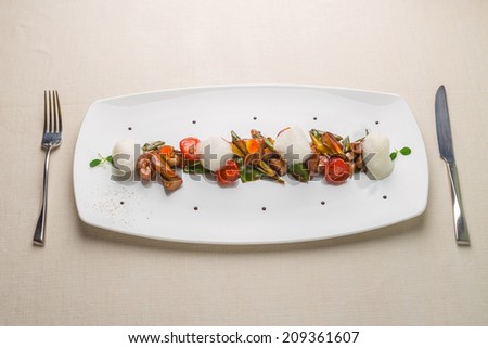 Warm salad with sweetbread, peaches, tomatoes and mousse. Fine cuisine