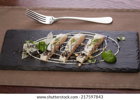 Whitefish fillet served on stone plate