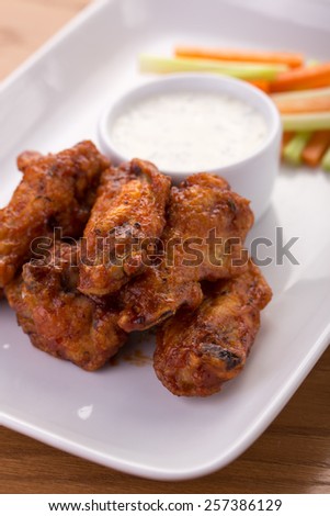 chicken wings with blue cheese dip isolated on wooden table