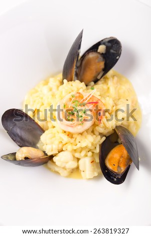 Seafood risotto with shrimp and mussels isolated on white background