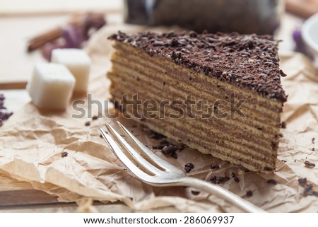 Chocolate cake and dessert fork on paper napkin