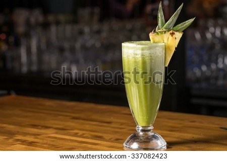 Pineapple smoothie in glass on bar counter