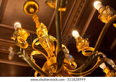 Element of beautiful crystal chandelier in a room. Close-up