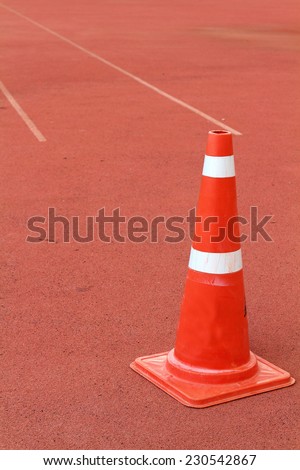 A Traffic cone on  the rubber flooring
