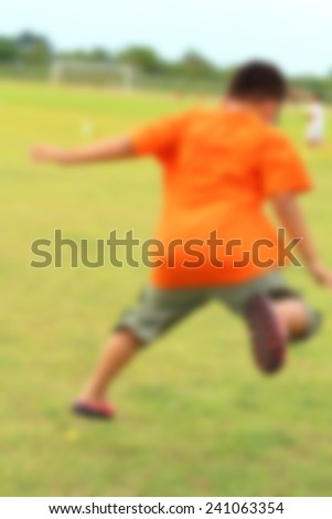 Blur The kid big jump in soccer field