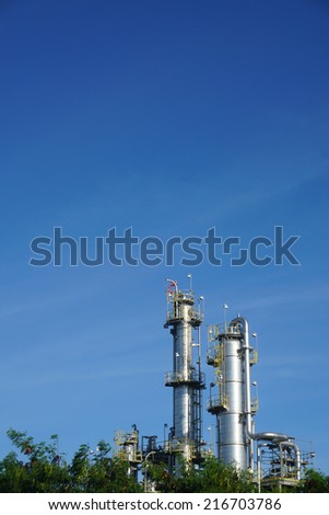 Petrochemical factory and green nature on blue sky backgound