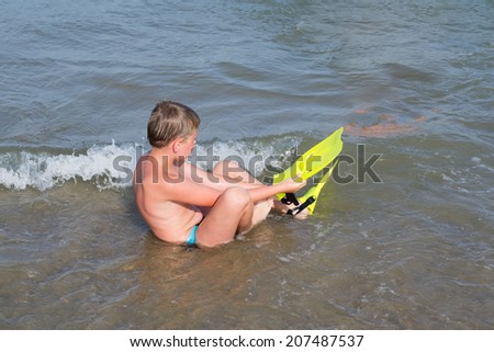 boy dressed fins, goes swimming in the sea
