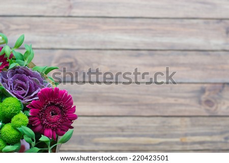 bouquet of red flowers on a wooden background