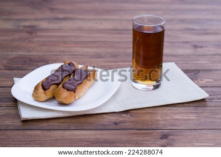 choux pastry with chocolate and a glass of juice