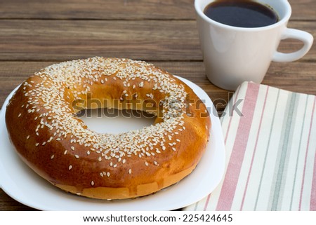 bagel with sesame seeds and black coffee