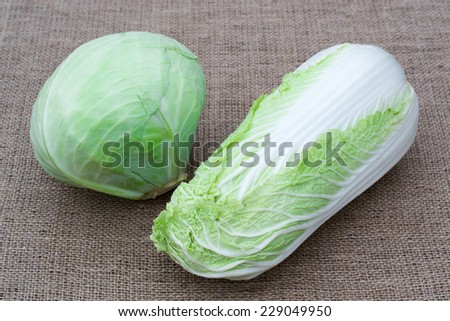 two kinds of white, salad, cabbage lies on burlap background