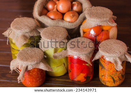 Jars of canned preserved tomatoes, zucchini, peppers, eggplant, adjika