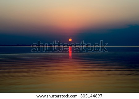 turquoise sunset with reflection in sea surface