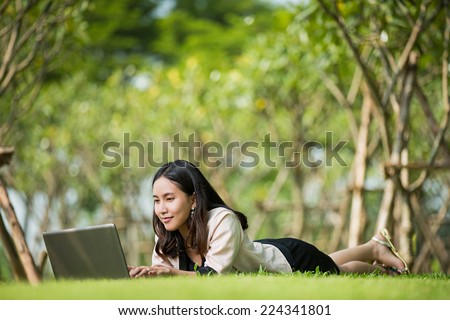 Asian student women lying notebook computer with a smiley face
