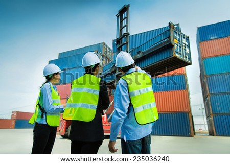 A group of engineers are ordering to drop  the container