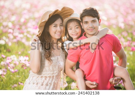 Asian family I bring my daughter to the park flower Cosmos