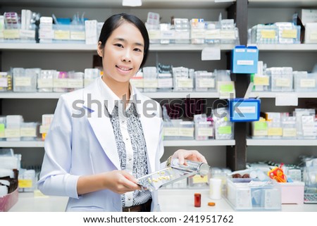 women pharmacist pharmacy pouring drugs into Tray