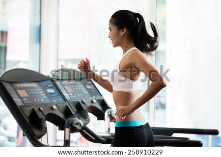A woman jogging on a treadmill. to lose weight And good health