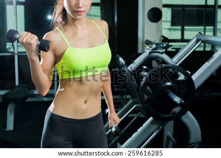 Woman exercising in the gym She shows off her arms tied spread.