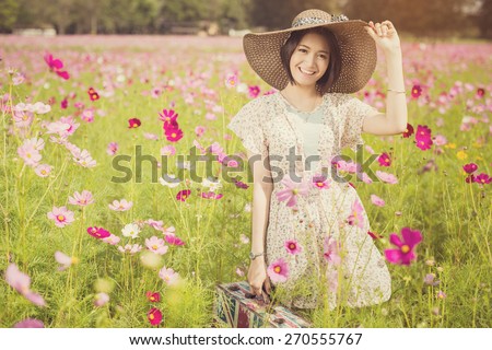 Asian woman holding a bag with the flag of England. Flowers to collect tax She relaxed a trip to the garden,vintage color