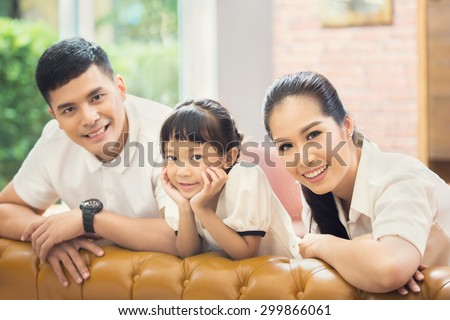 Asian family Sitting on sofa and smiling