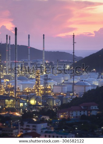 A large oil refinery Near the community As the early evening light, or light Twilight.