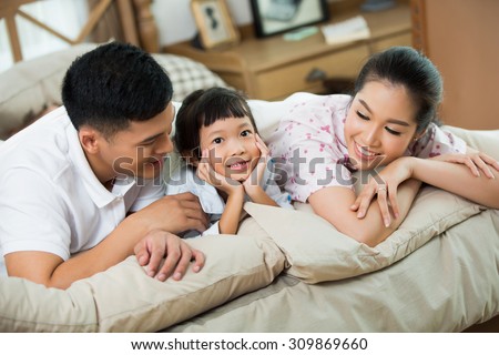 Asian family daughter tells some stories listen to parents everyone is happy