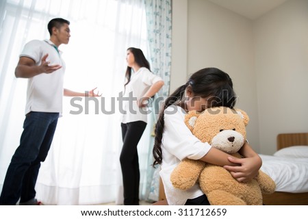 Parents are quarreling daughters feel stressed. She cried, hugging a teddy bear
