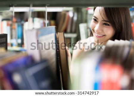 Asian women students books are selected from the bookshelf