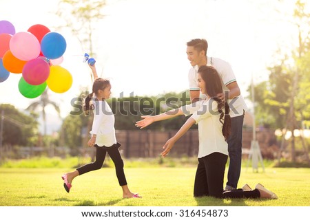 Daughter running to mother She enjoyed the play balloons