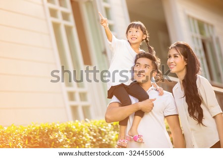 Asian family Happy Daughter pointing parents to look after her
