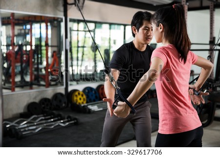 Trainer man are teaching Asian women Gym workout properly