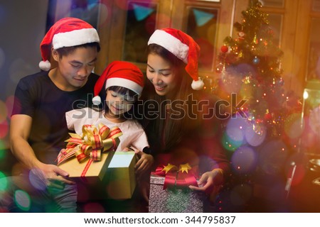 Asian family opening a gift box on christmas day happy
