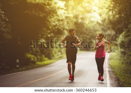 Couples take vacations jogging in the forest. The integrity and refreshing