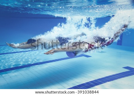 swimmer woman Jump from platform jumping a swimming pool.Underwater photo