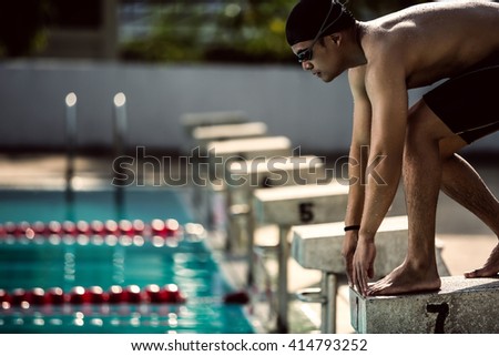 swimmer swimming competition pool.starting block in a swimming pool