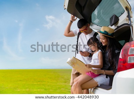 Asian family planning a trip mother and daughter looking at map