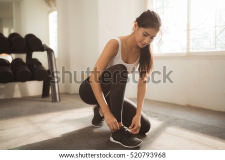 Asian women tie your shoes in the gym