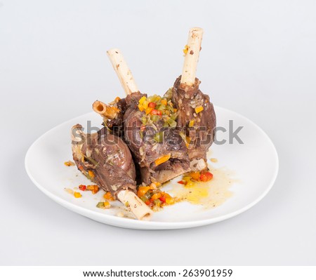 rabbit leg with chopped vegetables in the oven