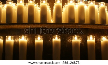 Wax lighted candles\
Photograph of some candles in a dark scene