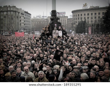 BELGRADE, SERBIA - 18, MARCH, 2006: People gather for the funeral procession of Slobodan Milosevics former president of the Federal Republic of Yugoslavia, in Belgrade, Serbia, on 18th of March, 2006.