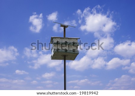 A bird house isolated on the blue sky