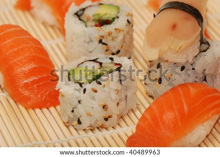 Set of sushi and rolls on a bamboo plate