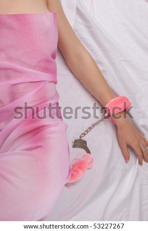 stock photo Elegant woman on bed tied in hand cuffs
