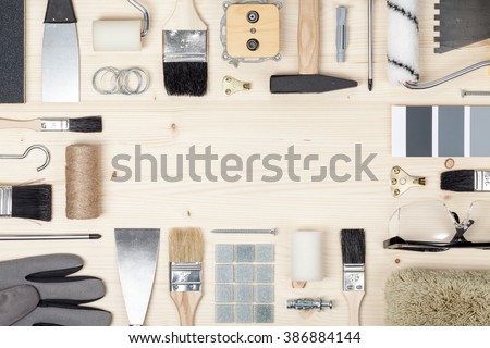 decorating and house renovation tools and accessories on wooden background. flat lay frame composition with copy space top view