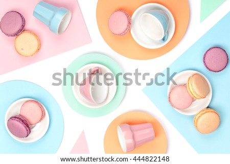 colourful still life with french dessert macaroons on white background top view. creative flat lay concept