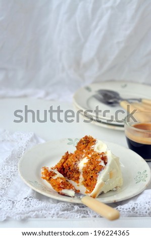 A slice of carrot cake with cream cheese frosting, selective focus