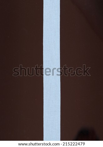 light blue ribbon isolated over black background