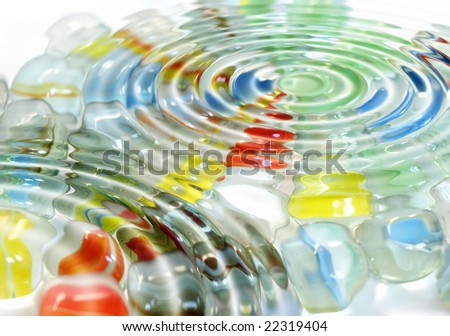 Colored marble spheres toy under water waves